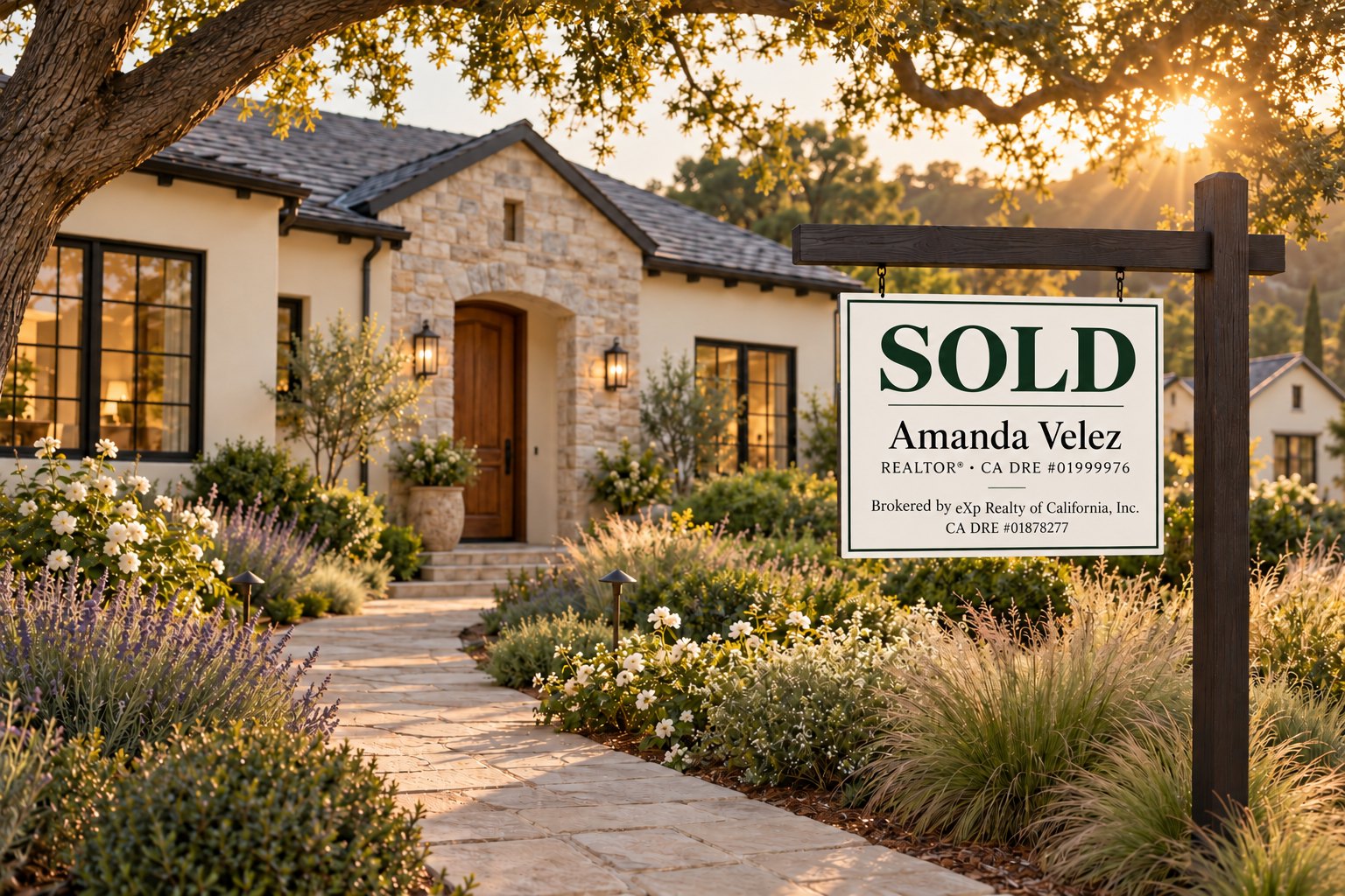 An Amanda Velez SOLD sign in the front garden of a stone and stucco East Bay home at golden hour